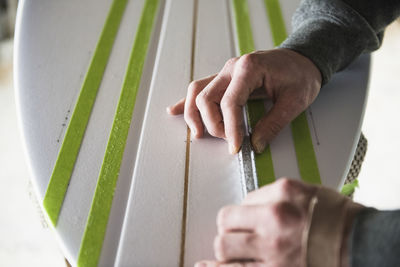 Surfboard shaper refining a new design