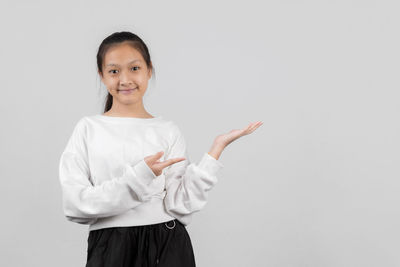 Portrait of a smiling young woman over white background