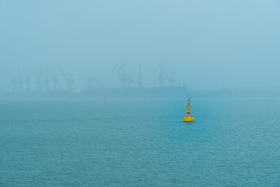 Sailboat sailing on sea against sky