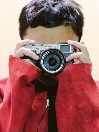 Portrait of a boy holding a digital camera