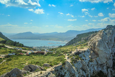 Panoramic view of sea and mountains against sky