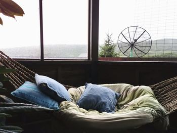 Man relaxing on bed by window at home