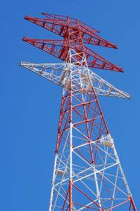 Low angle view of electricity pylon against clear sky