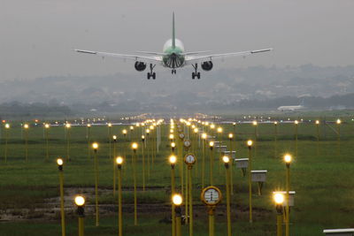 Low angle view of airplane against sky at dusk