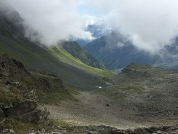 Scenic view of mountains against cloudy sky