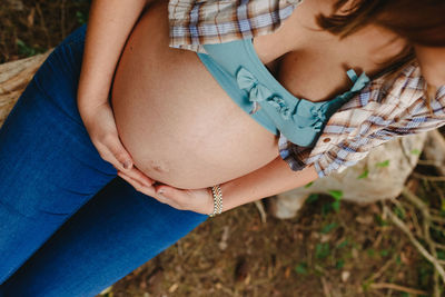 Midsection of woman with arms raised