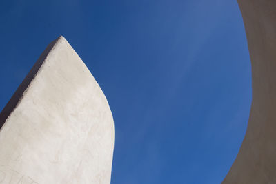 Low angle view of sculpture against blue sky