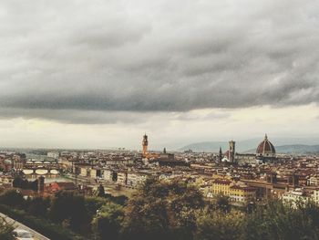 Cityscape against cloudy sky