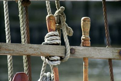 Ropes tied on wood against lake