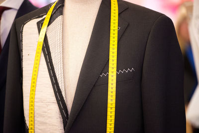 Suit with tape measure on mannequin