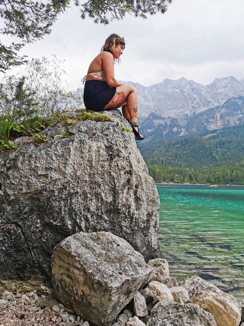 rock, mountain, one person, adult, leisure activity, nature, water, full length, beauty in nature, scenics - nature, adventure, activity, mountain range, vacation, holiday, trip, lifestyles, men, day, sky, travel, sports, land, sitting, tranquility, environment, side view, relaxation, outdoors, tree, climbing, plant, rock formation, landscape, lake, tranquil scene, mature adult, casual clothing, young adult, cloud, hiking, exercising, travel destinations, recreation, vitality, idyllic, rock climbing, cliff, looking, non-urban scene