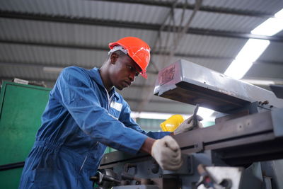 Rear view of man working in factory