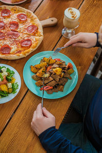 Midsection of man with food on table