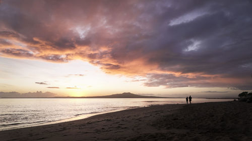 Scenic view of beach against sky during sunset