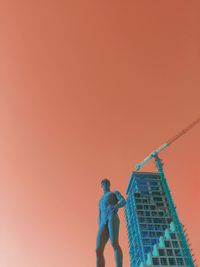 Low angle view of modern building against sky during sunset