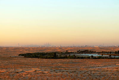 Scenic view of landscape against clear sky during sunset