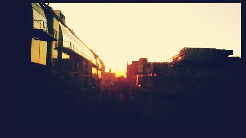 Buildings in city at sunset