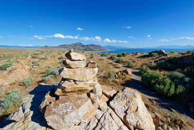 Rock formations on landscape against blue sky