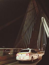 Cars on bridge in city at night