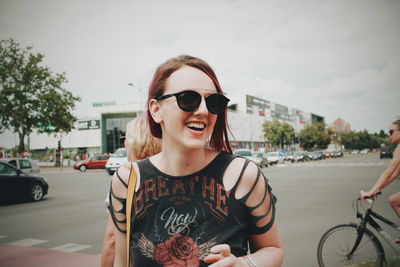 Portrait of smiling young woman in city