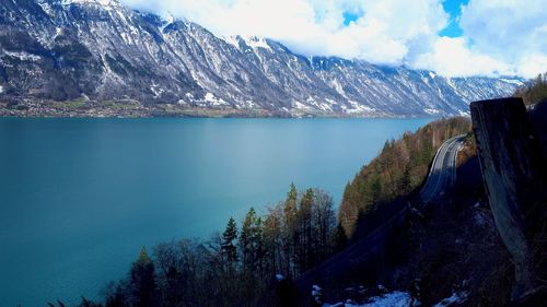 Scenic view of lake and mountains against sky