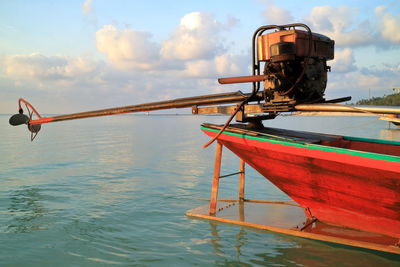 Cropped image of propeller boat moored on lake