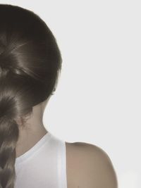 Cropped image of woman with braided hair against white background