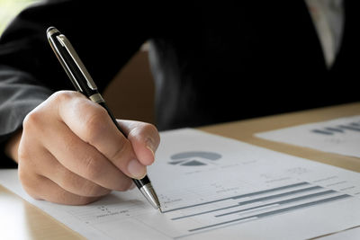 Close-up of hand holding paper