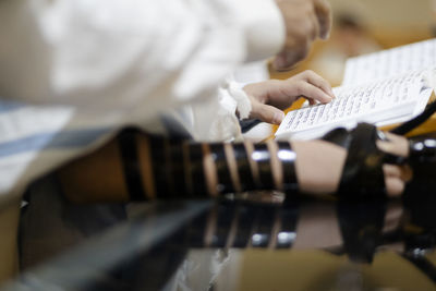 Midsection of woman reading book