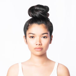 Portrait of a beautiful young woman over white background