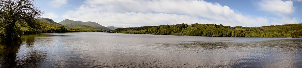 Panoramic view of river amidst trees against sky