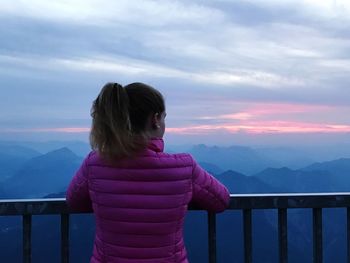 Rear view of woman looking at view against sky