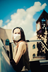 Young woman open car door and prepare to enter the car