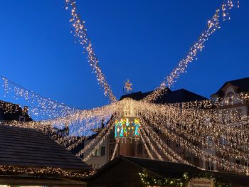 Low angle view of illuminated building against sky at night