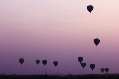 Low angle view of hot air balloons against sky during sunset