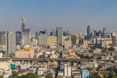 Modern buildings in city against clear sky