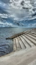 Scenic view of sea against cloudy sky