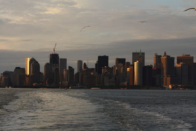 City at waterfront during sunset