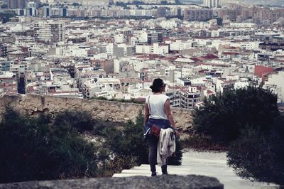 Rear view of man looking at city buildings