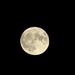 Low angle view of full moon against sky at night