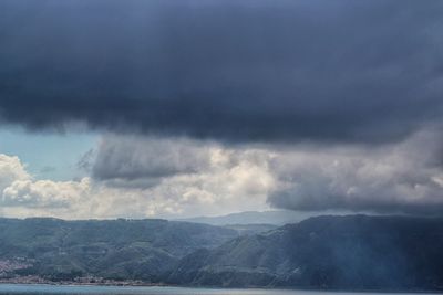 Scenic view of mountains against cloudy sky