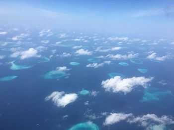 Aerial view of sea against blue sky