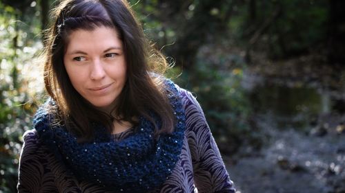 Smiling woman looking away in forest