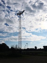 Low angle view of electricity pylon on field against sky