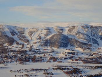 Scenic view of snow covered landscape against sky