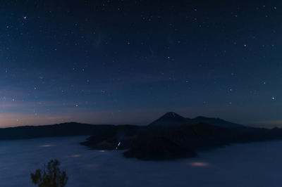 Scenic view of mountains against sky at night