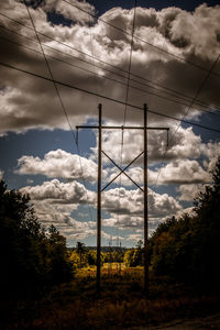 Low angle view of electricity pylon against sky