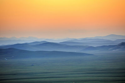 Scenic view of landscape against sky during sunset