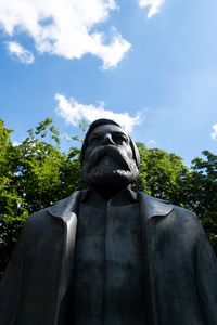 Low angle view of statue against trees