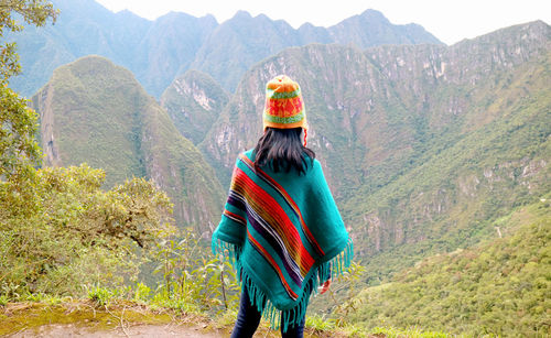 Rear view of woman standing on mountain